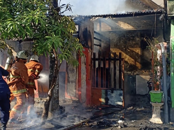 Petugas saat memadamkan api di warung nasi ayam geprek di Jalan Gubeng Airlangga II Nomor 15.
