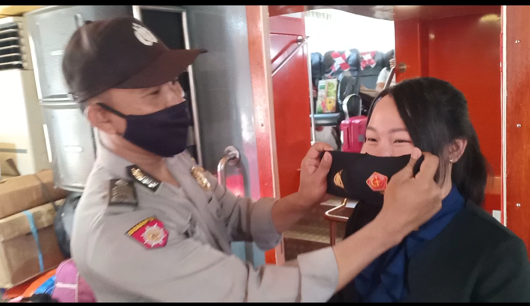 Kapolsek Pelabuhan Gresik, AKP I Made Jatinegara memberikan masker kepada penumpang kapal di pelabuhan, Senin (1/3/2021).