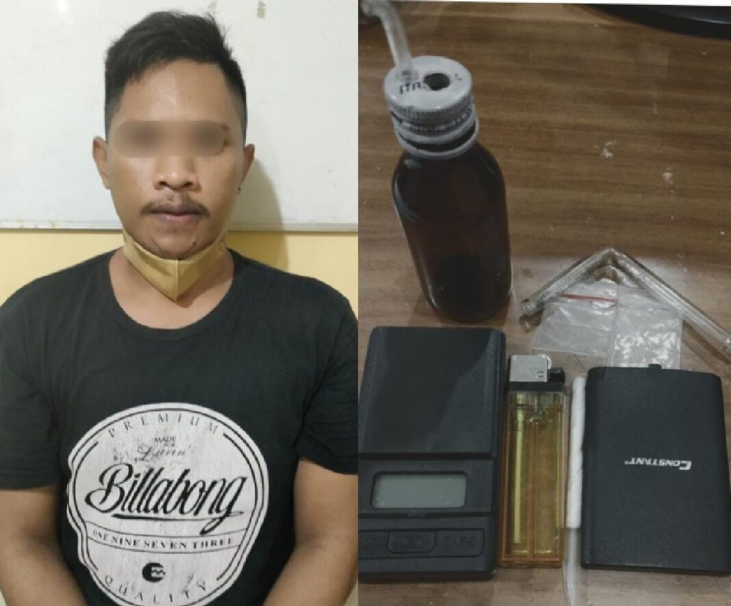 Tersangka Subeidi (30) beserta barang bukti saat diamankan di Mapolsek Wonokromo.