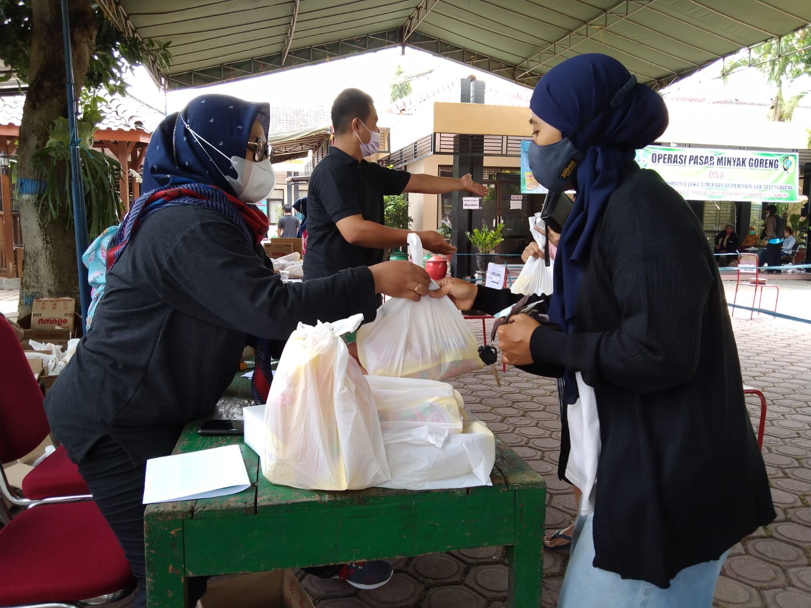 Warga membeli minyak goreng bersubsidi operasi pasar di Disperindag dan Pasar Tulungagung.