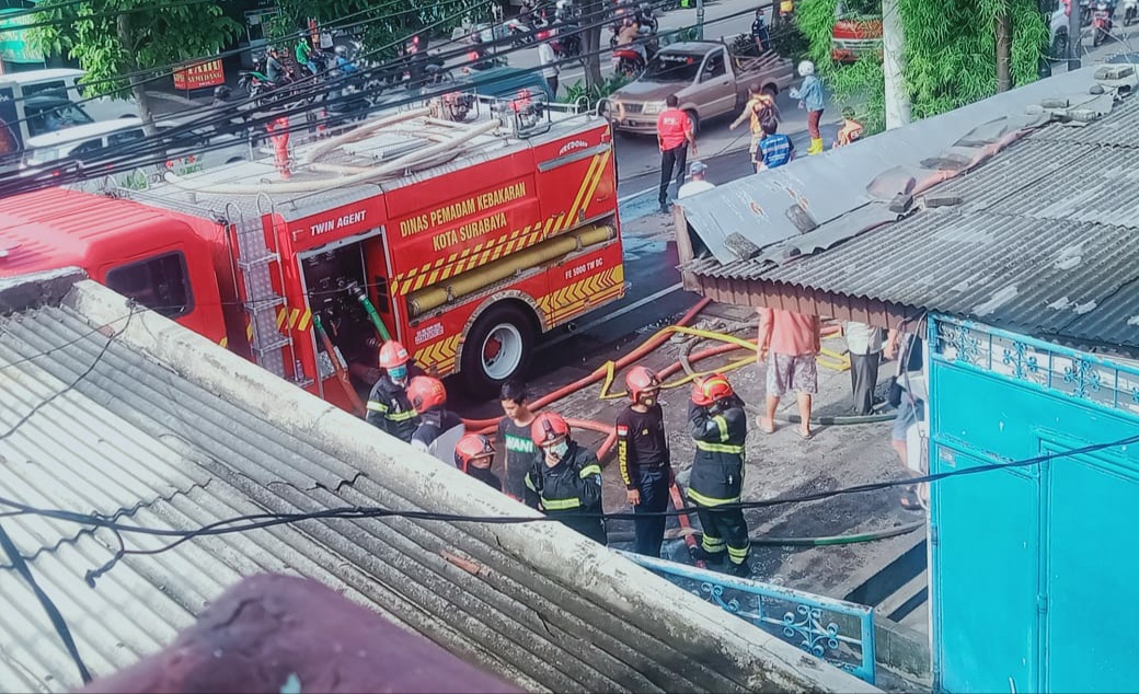 Petugas pemadam kebakaran saat memadamkan api di toko bangunan yang terbakar. (Foto IST) 