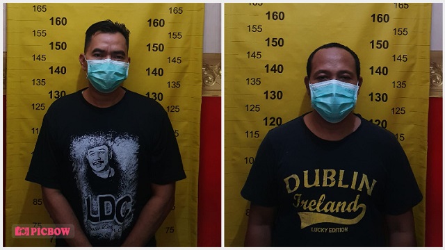 Dua tersangka pengedar uang palsu.