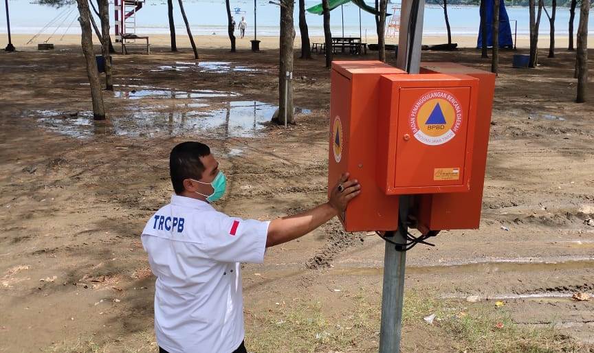 DILEPAS: Salah seorang petugas Badan Penanggulangan Bencana Daerah (BPBD) Kabupaten Tulungagung, menunjukkan alat peringatan dini tsunami yang dilepas, Senin (28/12/2020). | BCSJ/Noyo